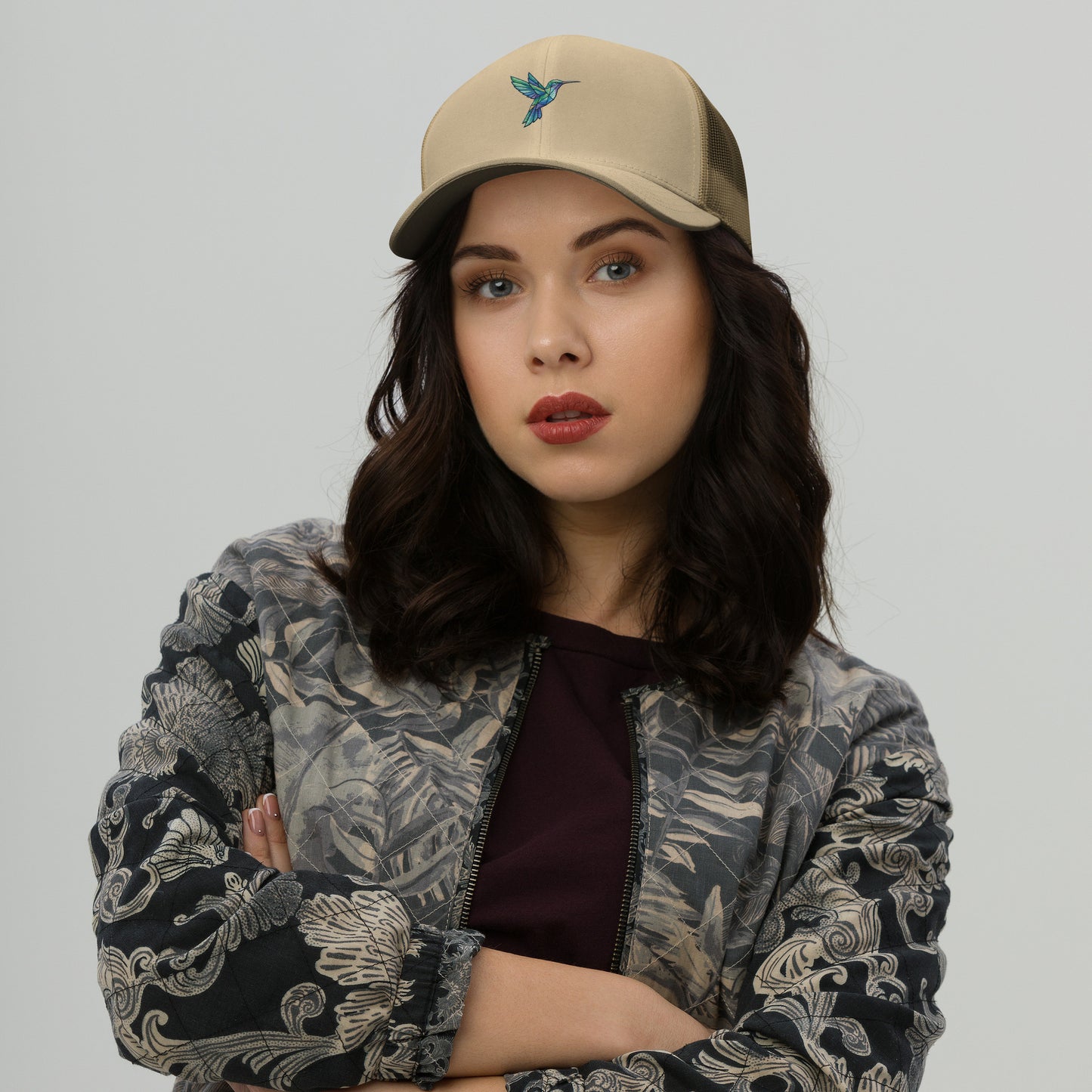 Modern geometric hummingbird illustration with colorful polygon shapes designed for a premium minimalist khaki hat.