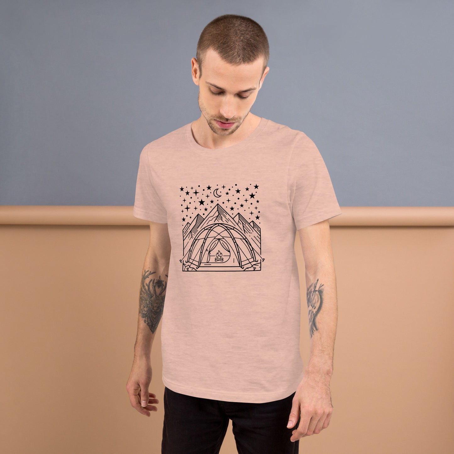 Minimalist camping graphic featuring a tent beneath a star-filled sky with mountains on a premium unisex peachy t-shirt
