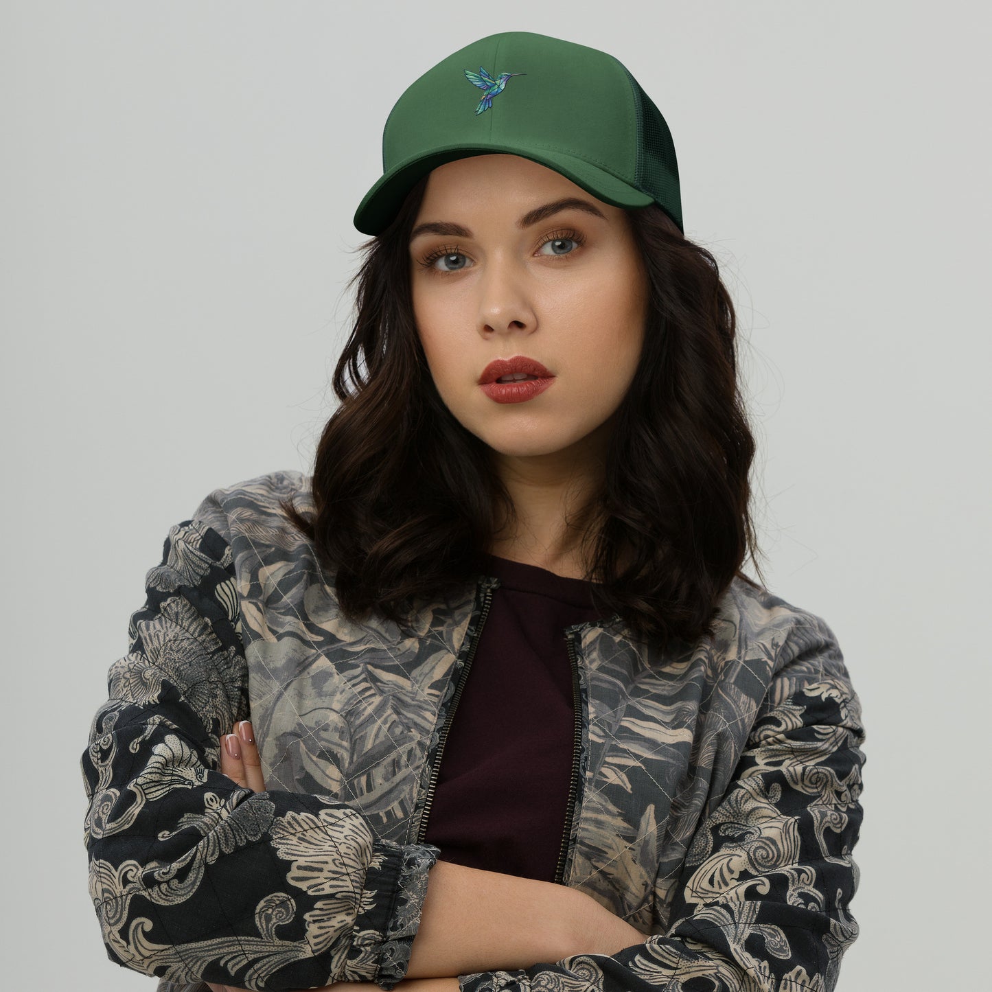 Modern geometric hummingbird illustration with colorful polygon shapes designed for a premium minimalist evergreen hat.