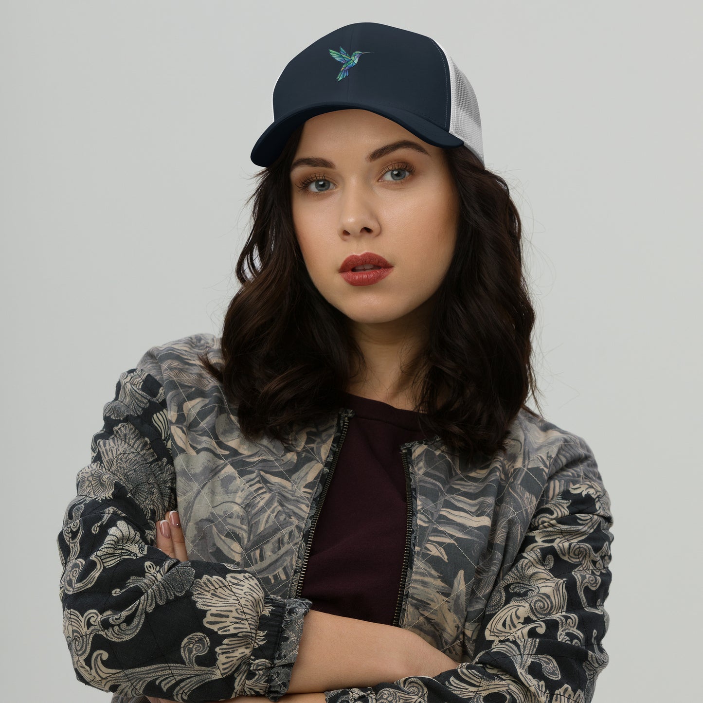 Modern geometric hummingbird illustration with colorful polygon shapes designed for a premium minimalist navy white hat.